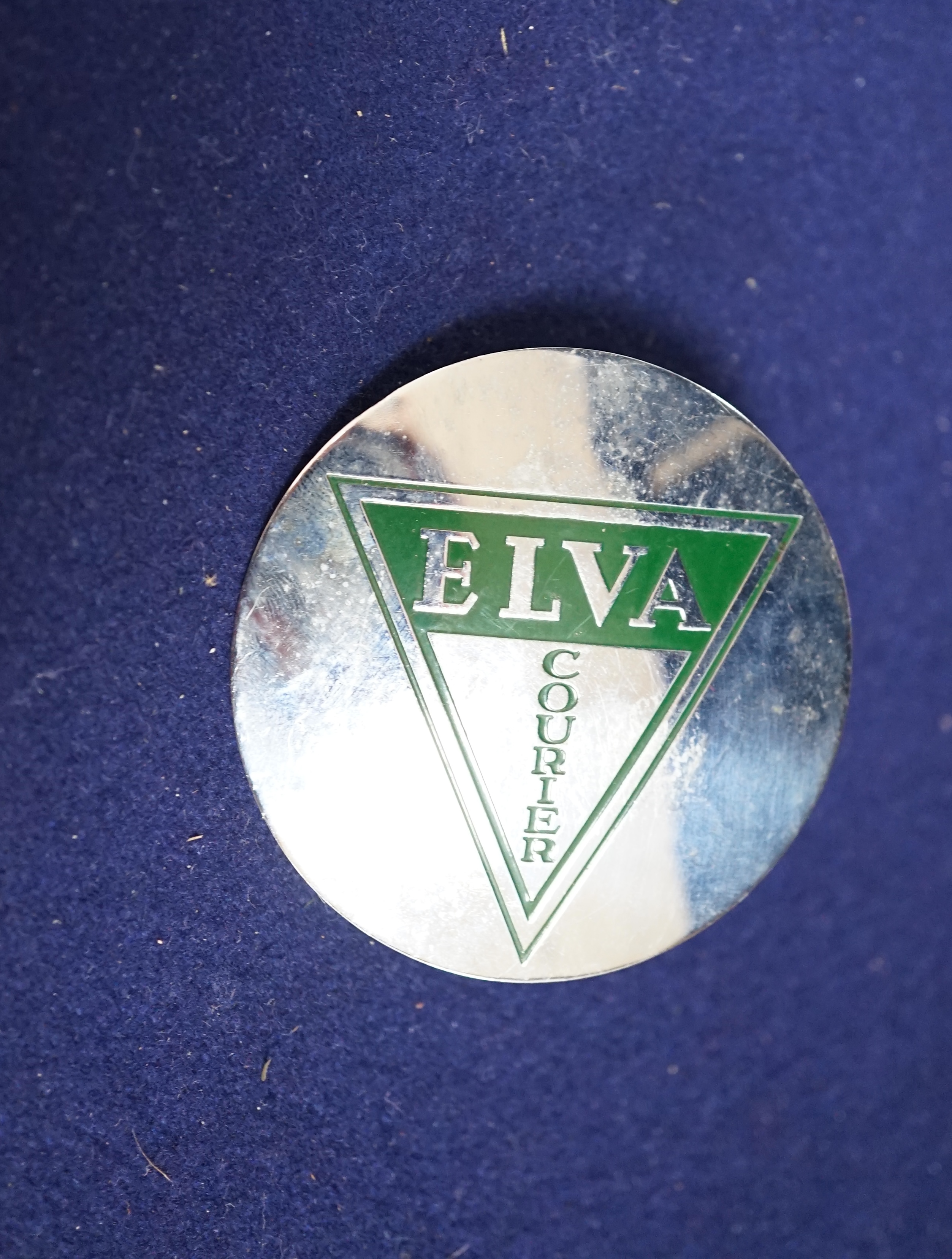 Automobilia interest; an Elva Courier car badge, a Goodwood B.A.R.C.1965 badge no.1135, three M.M.C (mouse badges and a WL.O.C badge and an AC Owners Club mascot badge. Condition - fair to good.